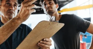 2 men with clipboard talking